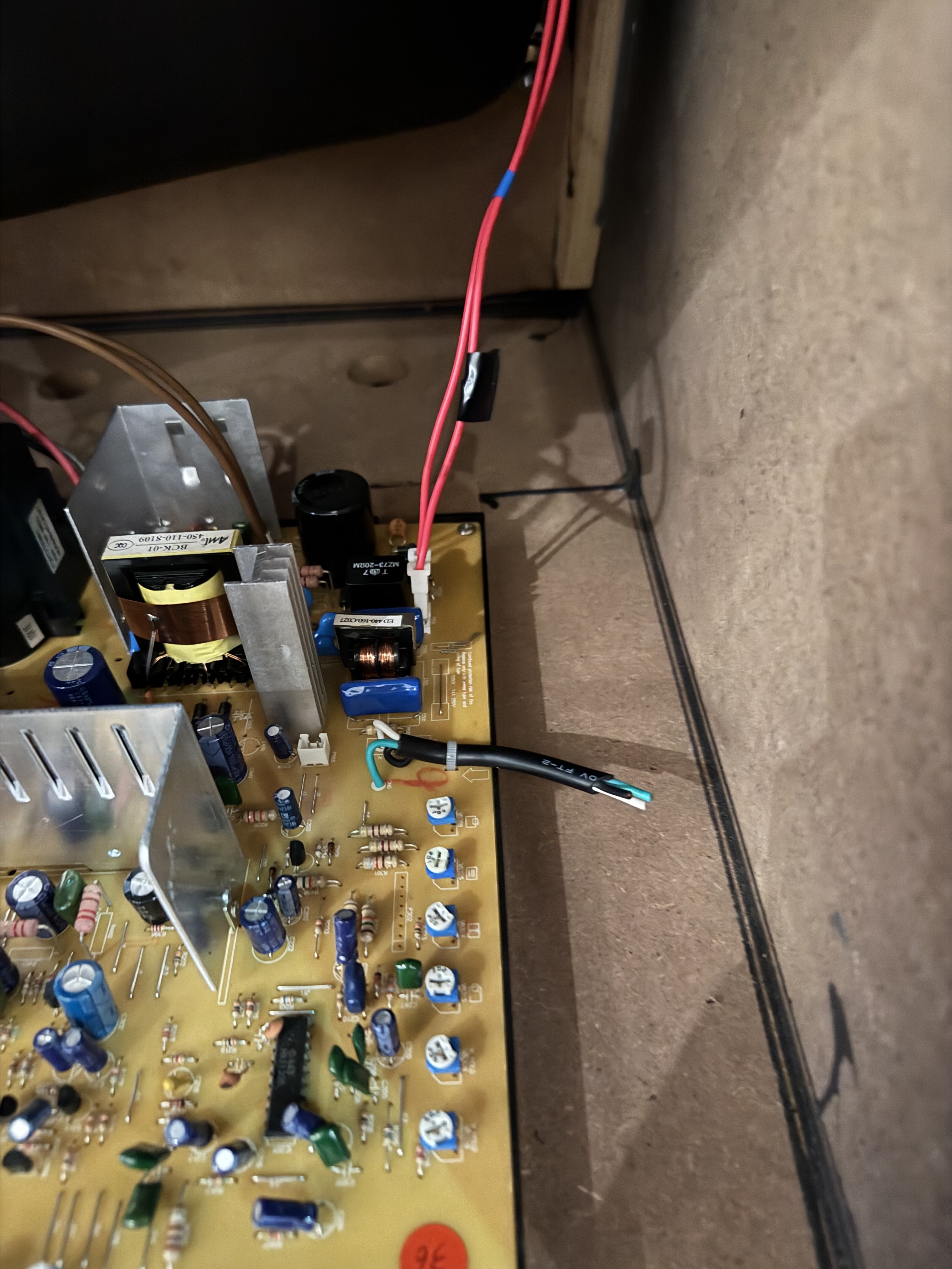 The cut power cord inside the cabinet